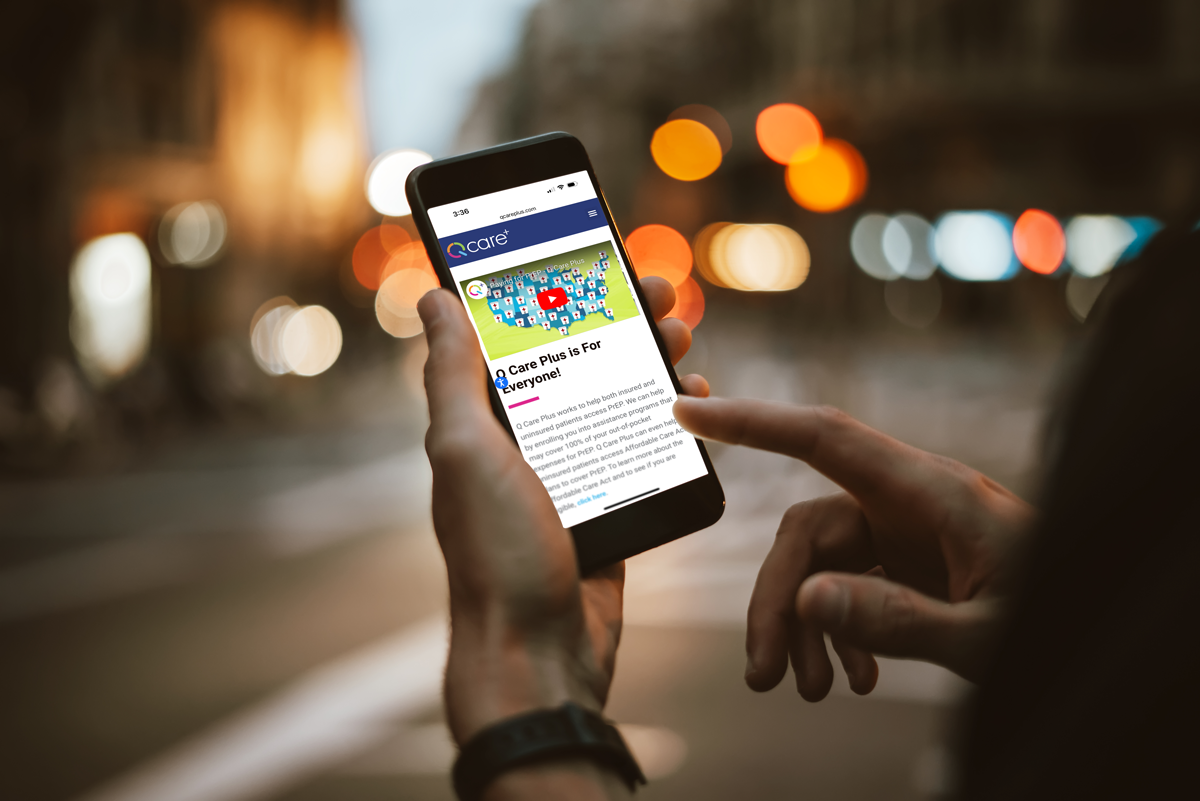 Person browsing the Q Care Plus website on a mobile device with the headline "Q Care Plus is for Everyone!"